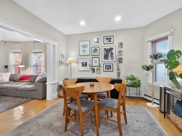 a dining room with furniture and wooden floor