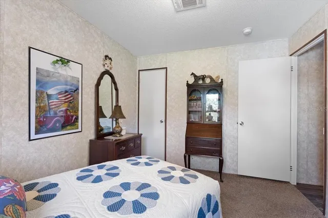 a bedroom with a bed couch and window