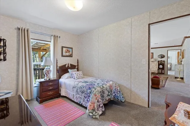 a bedroom with a bed and with furniture