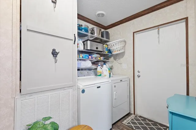 a kitchen filled with stainless steel appliances granite countertop a sink a stove and a wooden floor