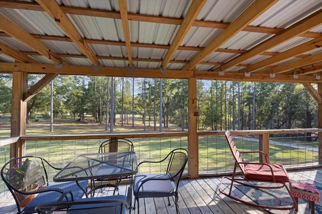 a view of swimming pool with outdoor seating and trees