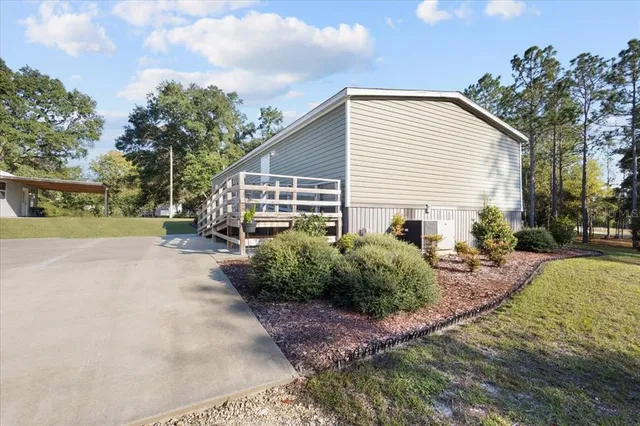 a view of a house with backyard and sitting area