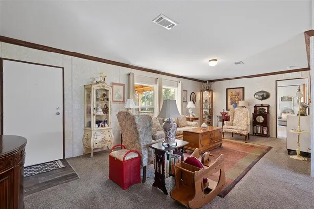 a living room with furniture a clock and a large window