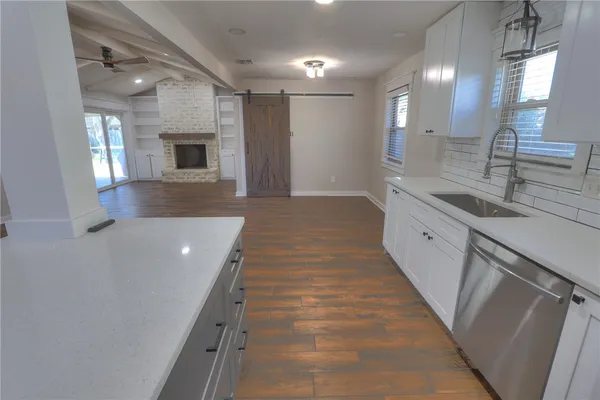 a bathroom with a sink a large mirror and a shower