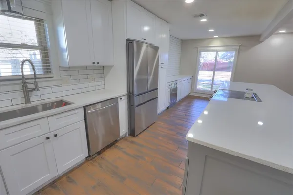 a kitchen with stainless steel appliances a refrigerator and a sink