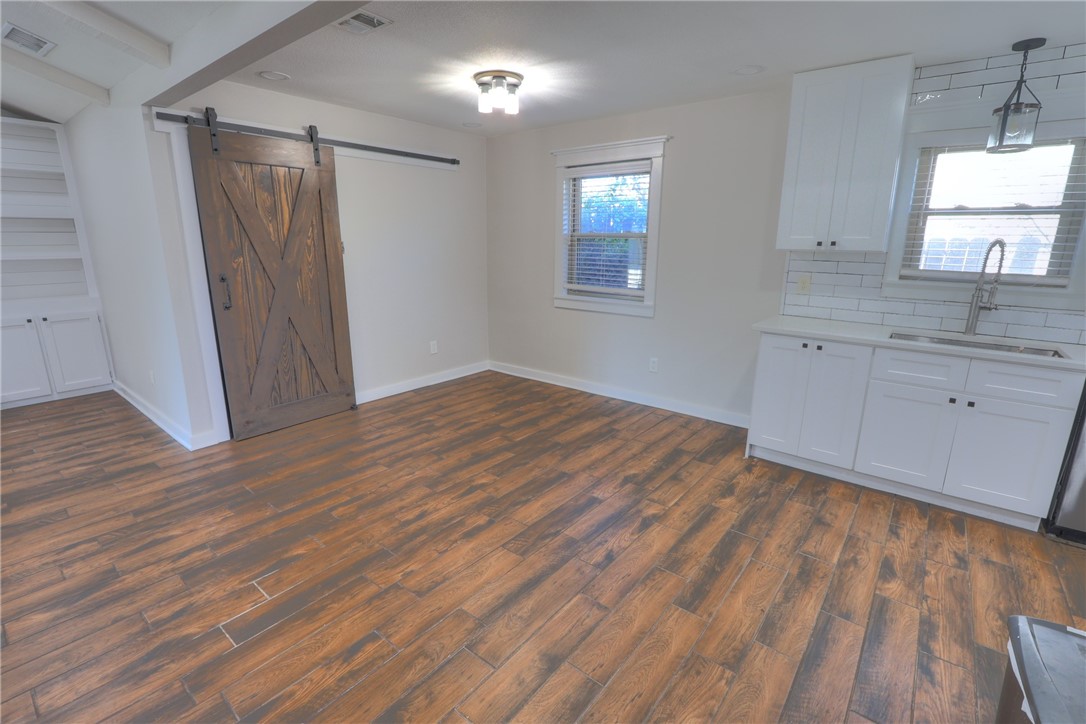 5209 Bromley Drive Corpus Christi, TX 78413 - Photo 15 of 31 wooden floor in an empty room with a window