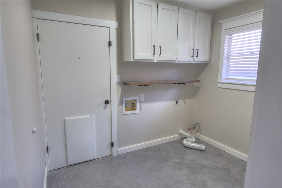 5209 Bromley Drive Corpus Christi, TX 78413 - Photo 17 of 31 a view of cabinets and utility room with a window