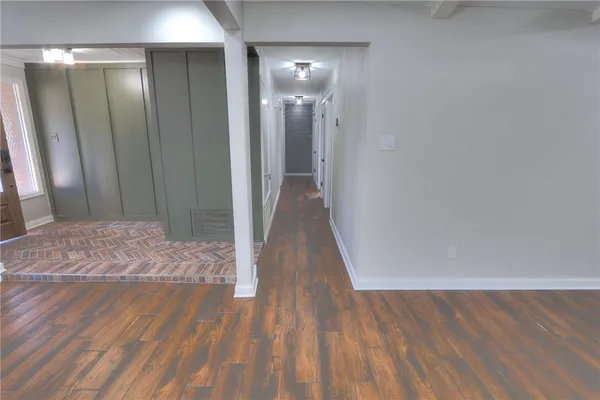 a view of a room with wooden floor