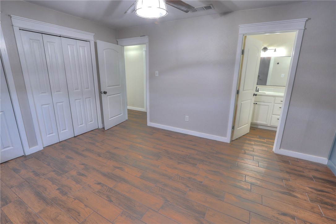 5209 Bromley Drive Corpus Christi, TX 78413 - Photo 27 of 31 an empty room with wooden floor and mirror