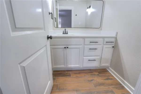 a bathroom with a sink a vanity and a mirror