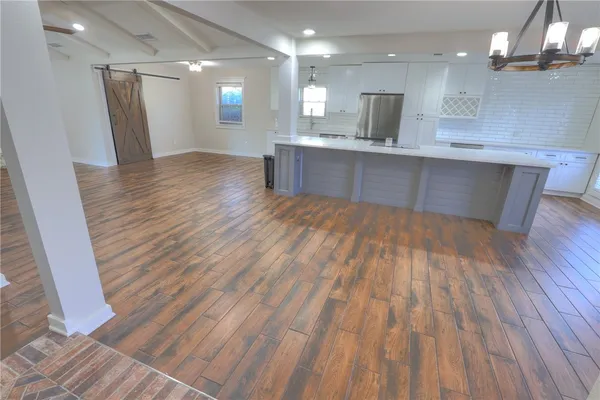 a view of kitchen and sink with wooden floor