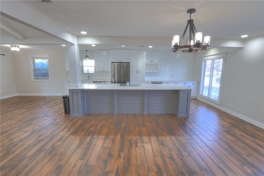 5209 Bromley Drive Corpus Christi, TX 78413 - Photo 6 of 31 a view of kitchen with granite countertop cabinets stove and wooden floor