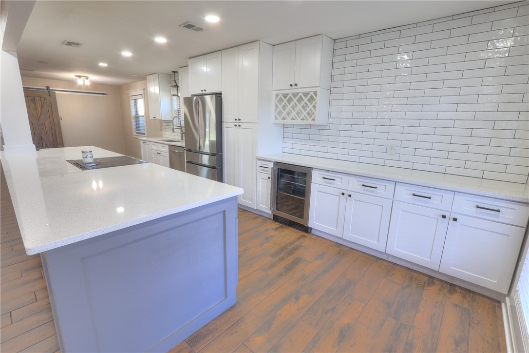 5209 Bromley Drive Corpus Christi, TX 78413 - Photo 9 of 31 a large kitchen with stainless steel appliances a large counter top a stove a refrigerator and a refrigerator