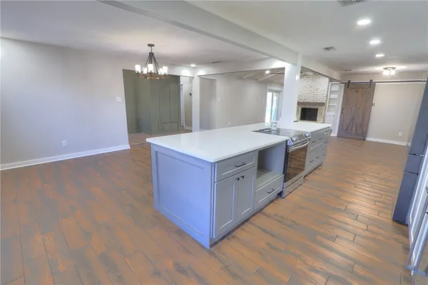 a kitchen with a sink and wooden floor