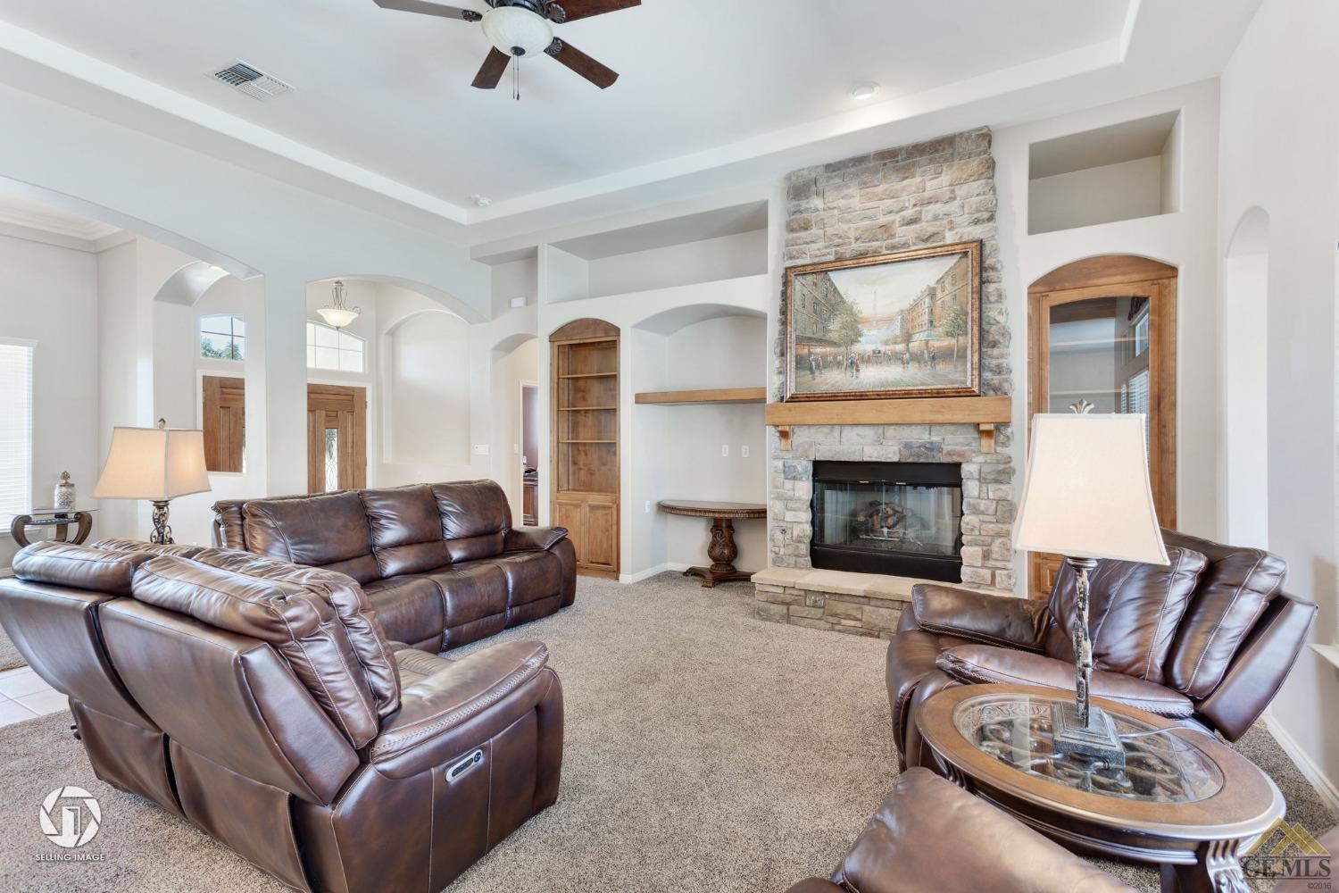 Undisclosed Address Bakersfield, CA 93313 - Photo 11 of 50 a living room with furniture and a fireplace
