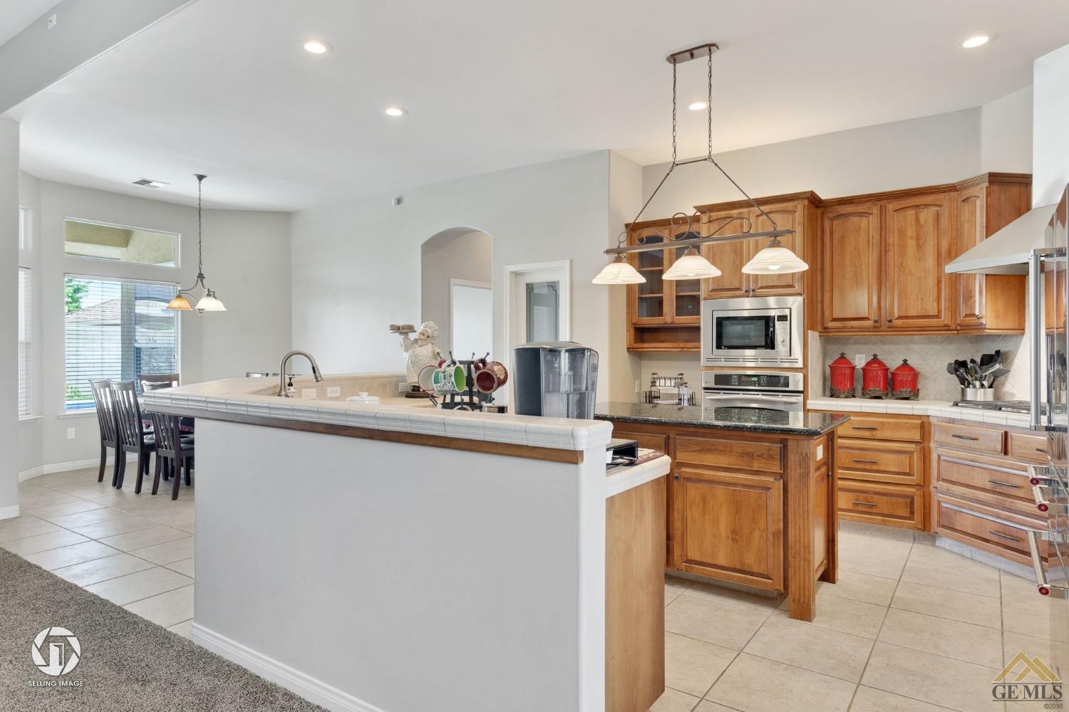 Undisclosed Address Bakersfield, CA 93313 - Photo 19 of 50 a kitchen with stainless steel appliances granite countertop a sink and cabinets