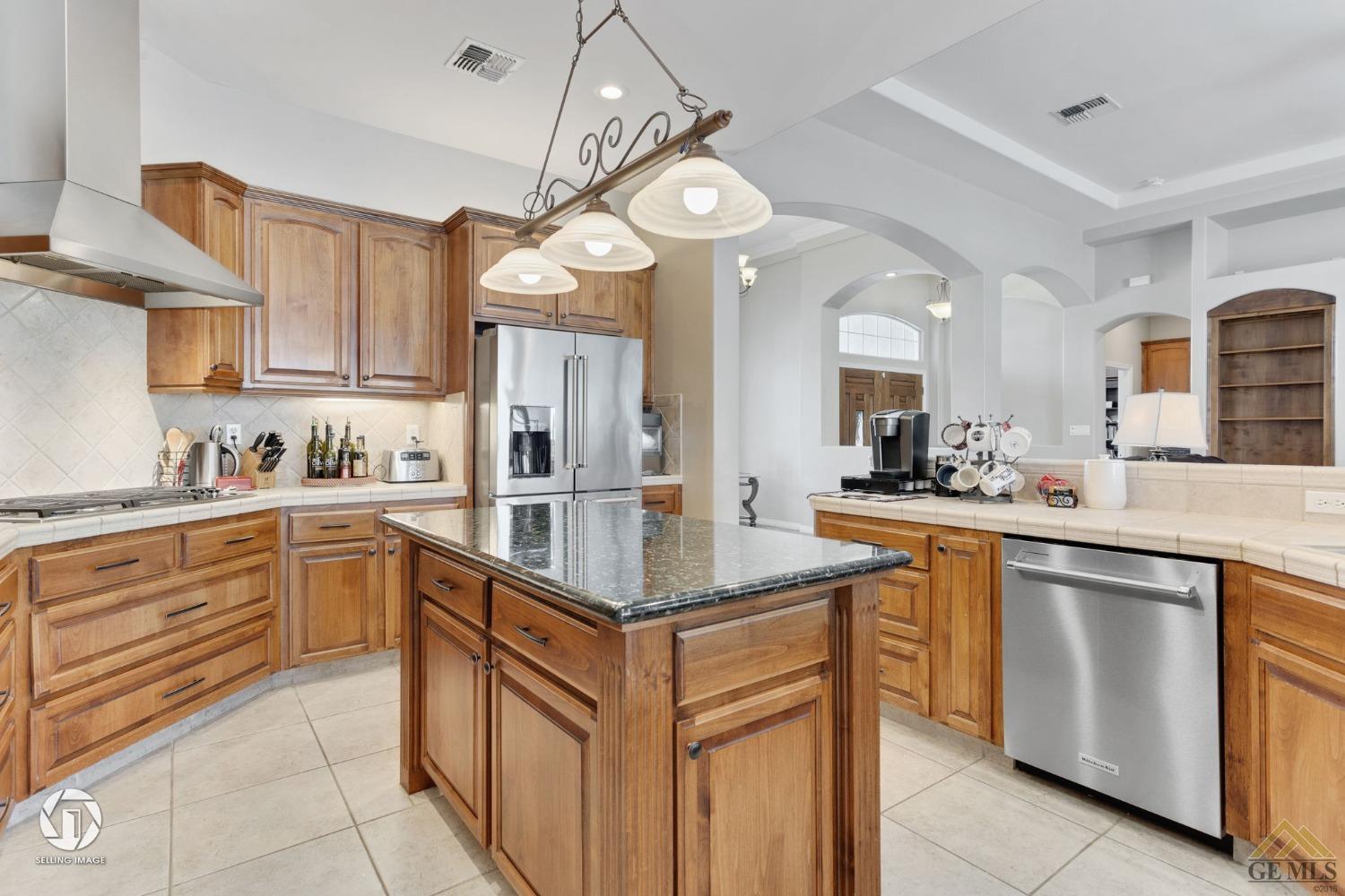 Undisclosed Address Bakersfield, CA 93313 - Photo 24 of 50 a kitchen with stainless steel appliances granite countertop a sink and cabinets