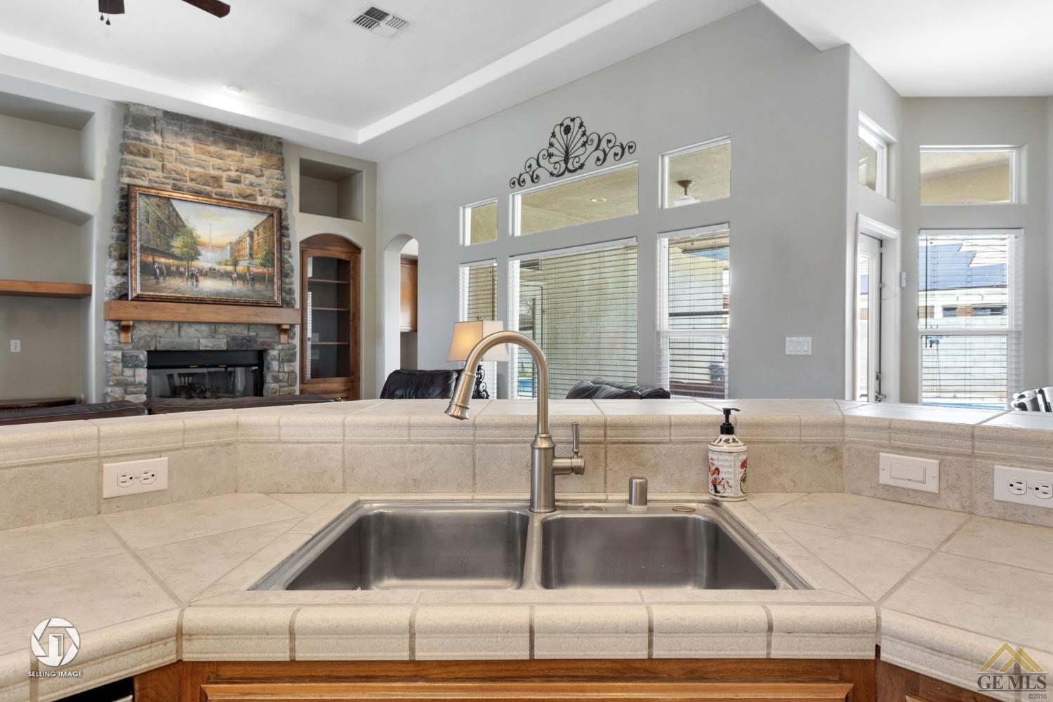 Undisclosed Address Bakersfield, CA 93313 - Photo 28 of 50 a kitchen with granite countertop a sink and a stove top oven