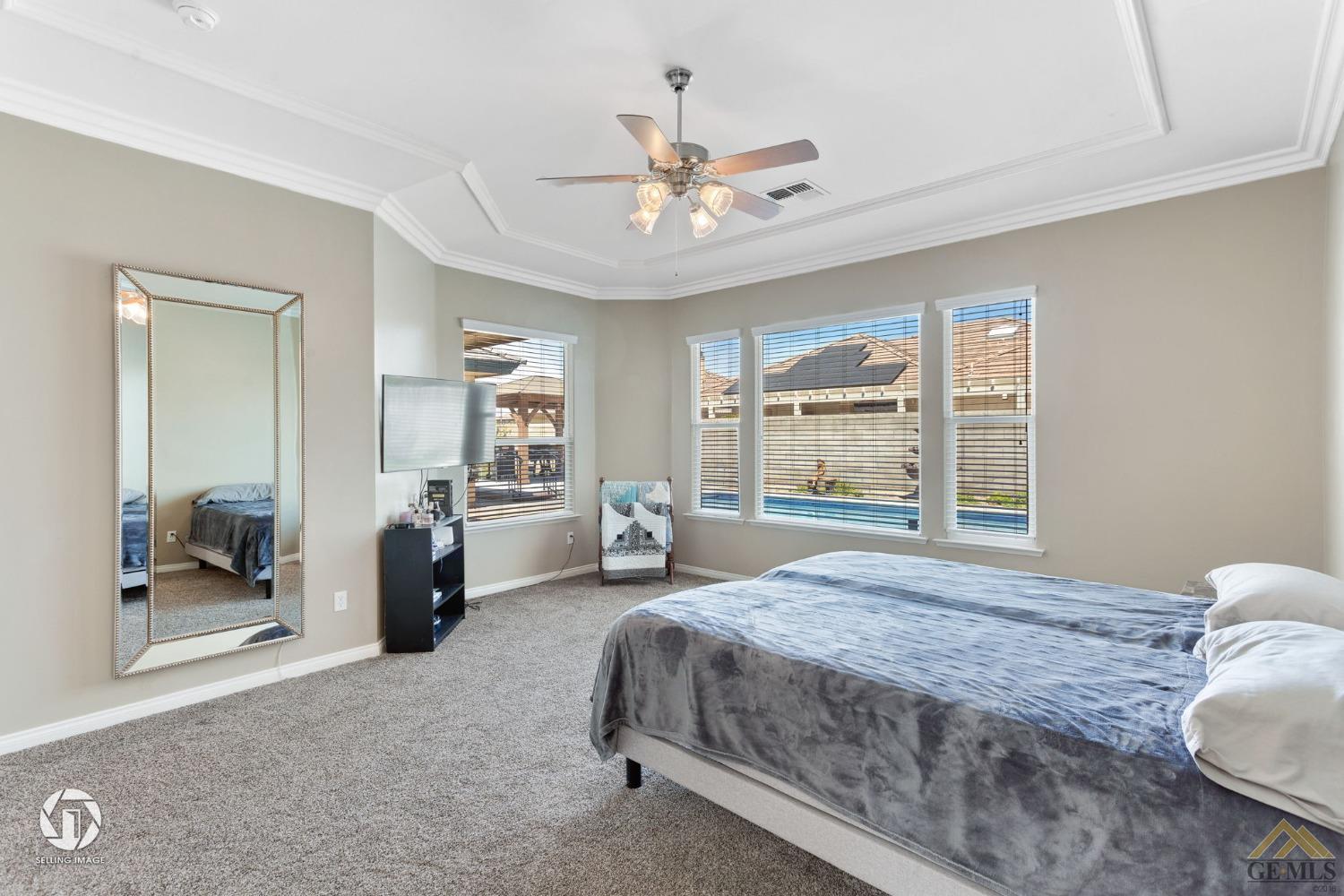 Undisclosed Address Bakersfield, CA 93313 - Photo 31 of 50 a bedroom with a large bed and a chandelier