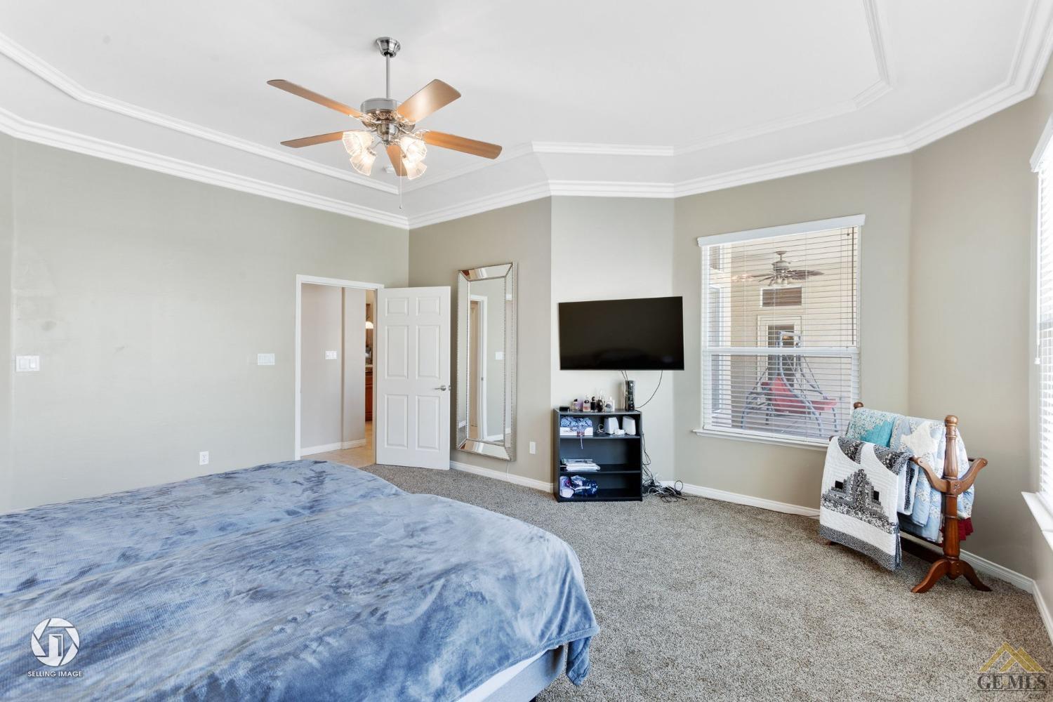 Undisclosed Address Bakersfield, CA 93313 - Photo 32 of 50 a bedroom with a bed flat screen tv and a window