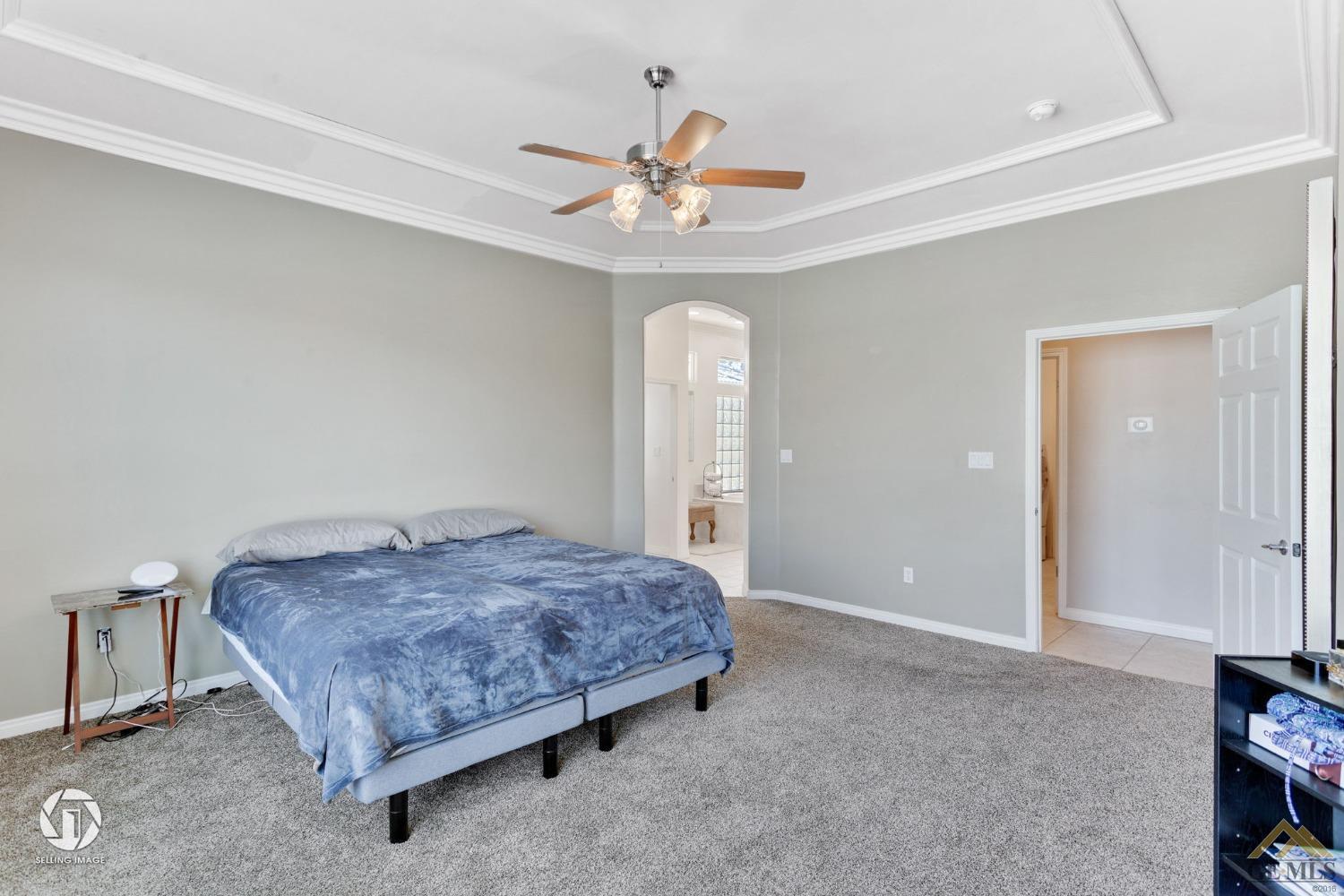 Undisclosed Address Bakersfield, CA 93313 - Photo 33 of 50 a bedroom with a bed and a chandelier