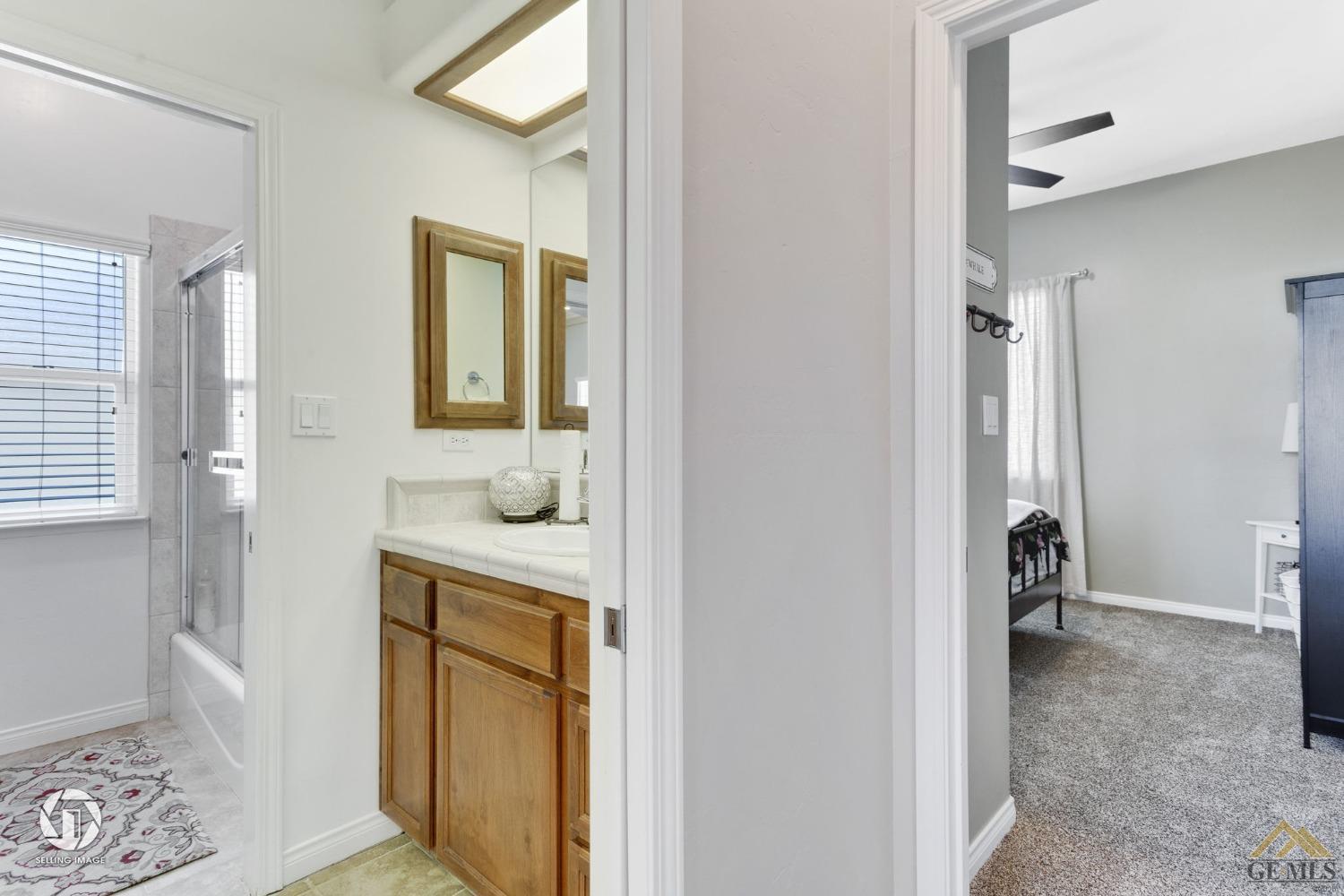 Undisclosed Address Bakersfield, CA 93313 - Photo 36 of 50 a bathroom with a sink a mirror and a toilet