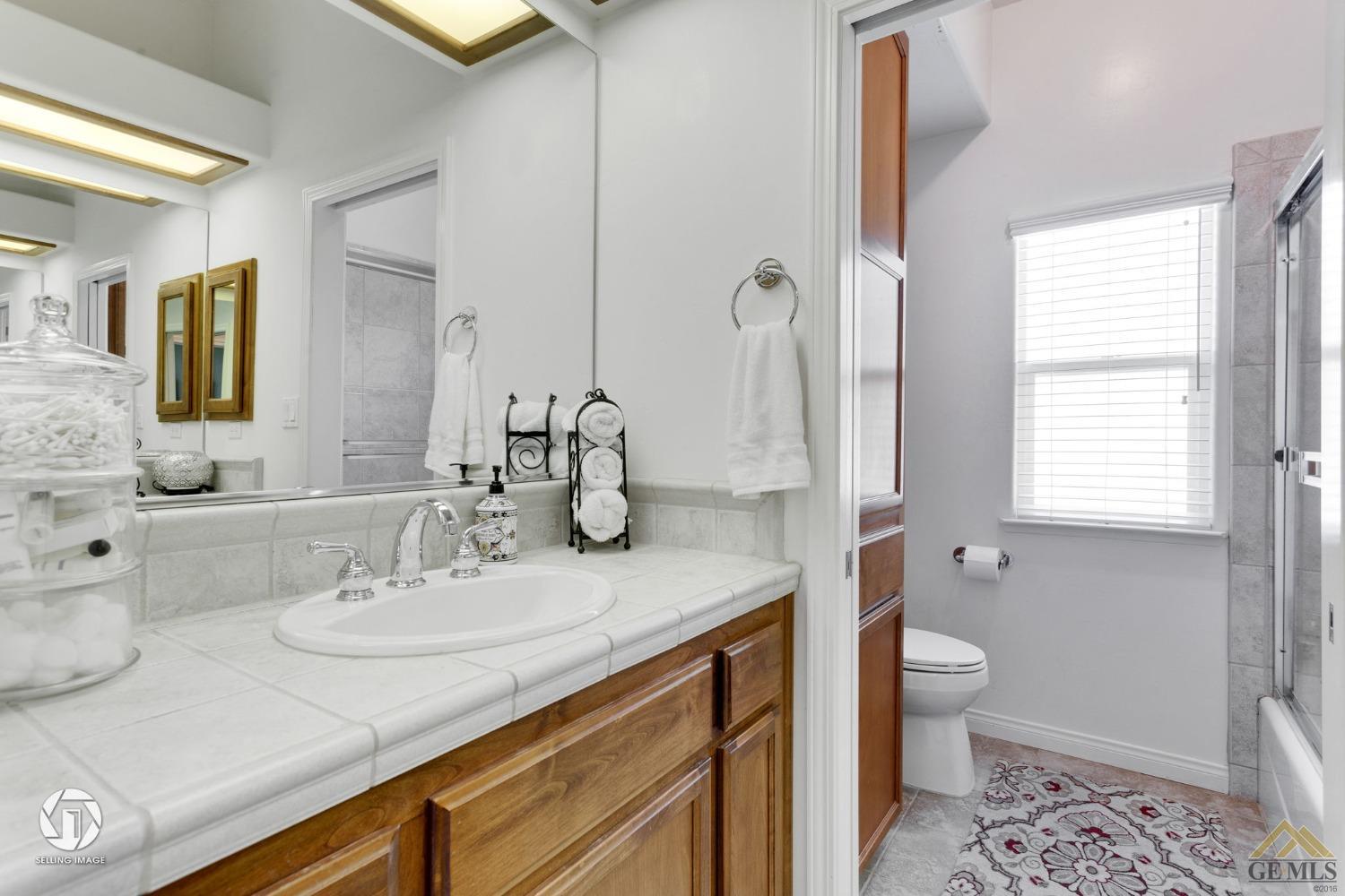 Undisclosed Address Bakersfield, CA 93313 - Photo 40 of 50 a bathroom with a sink and a mirror