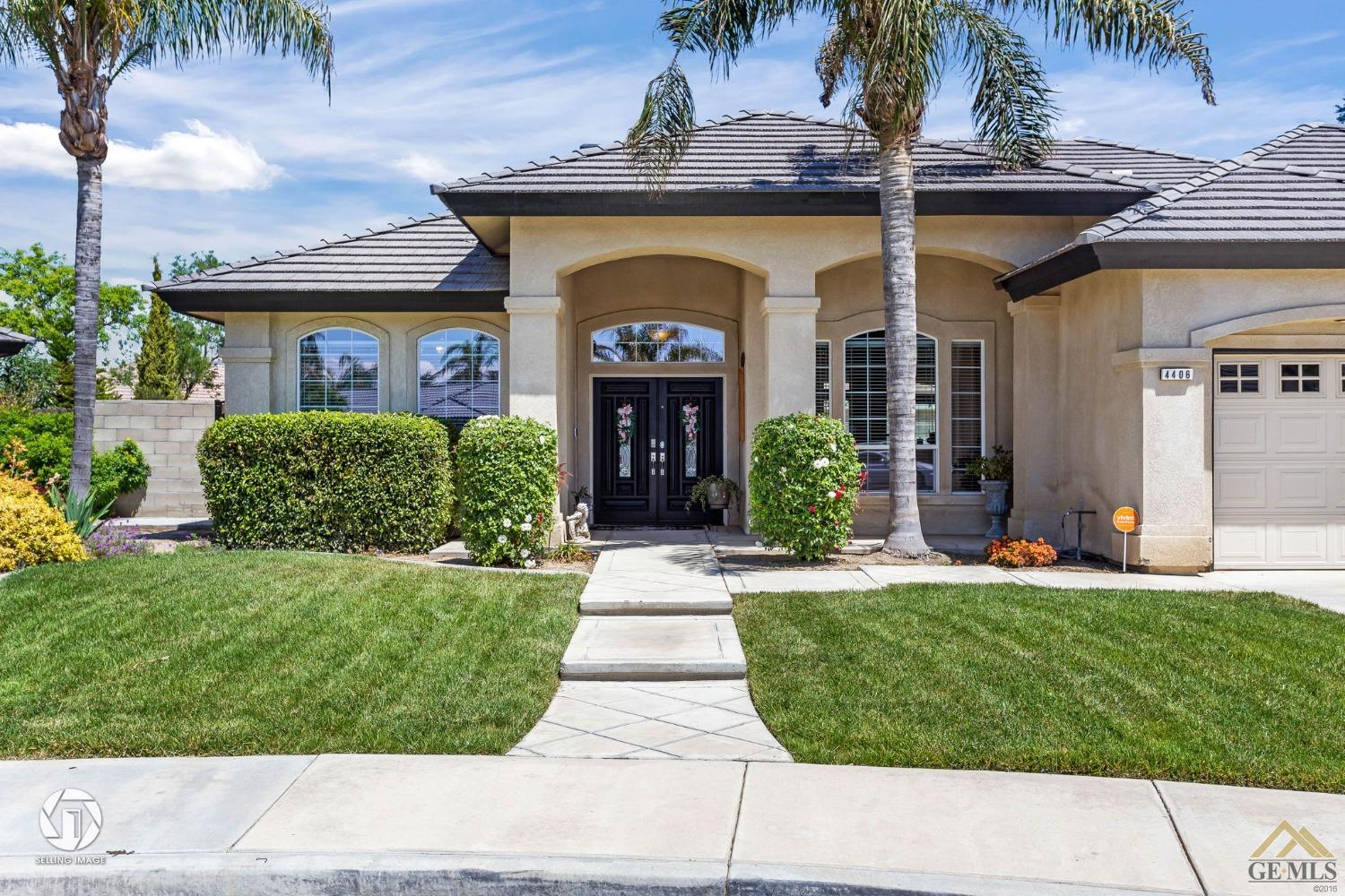 Undisclosed Address Bakersfield, CA 93313 - Photo 4 of 50 a front view of a house with a yard and potted plants