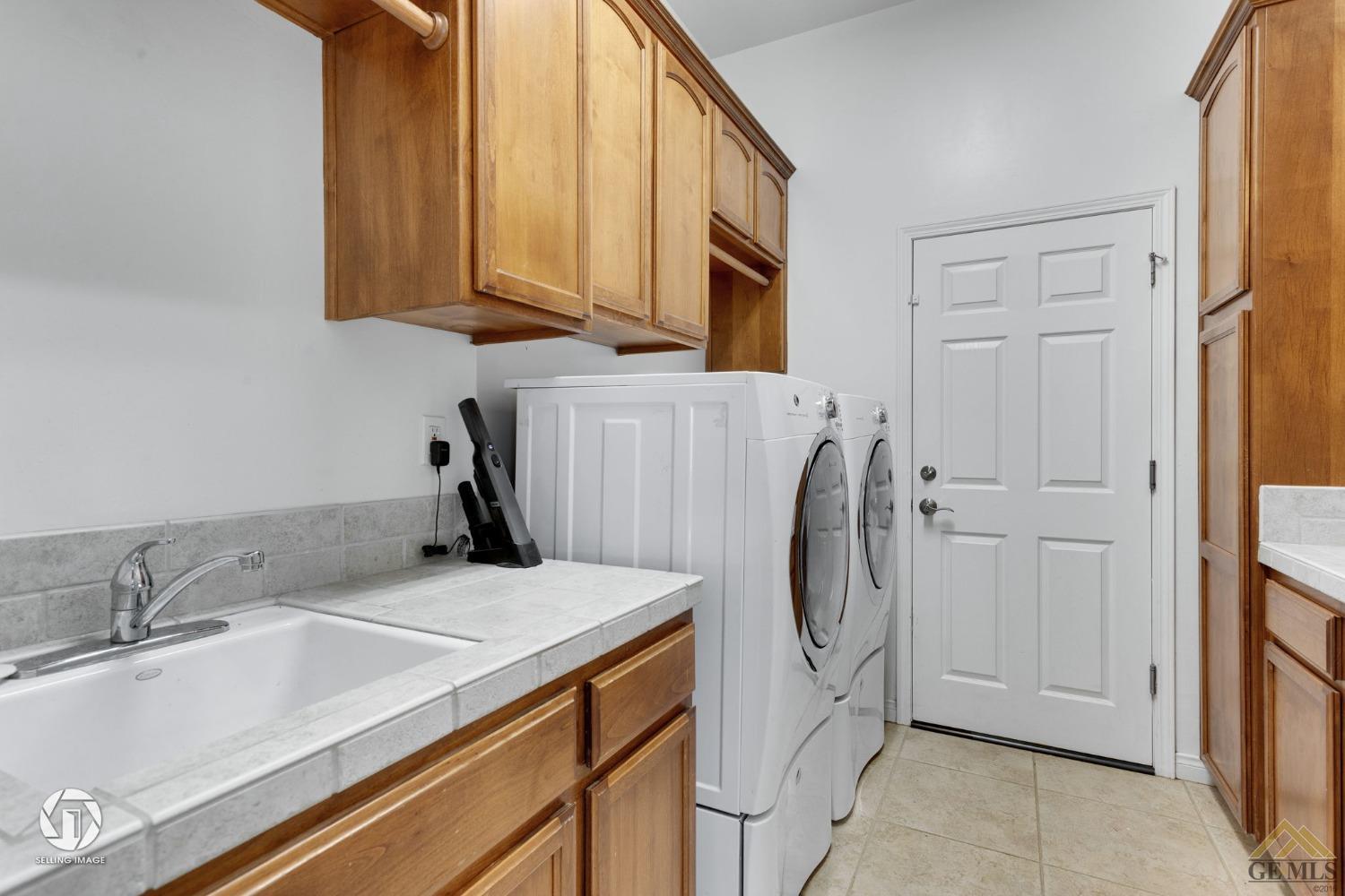 Undisclosed Address Bakersfield, CA 93313 - Photo 43 of 50 a bathroom with a sink and a washing machine