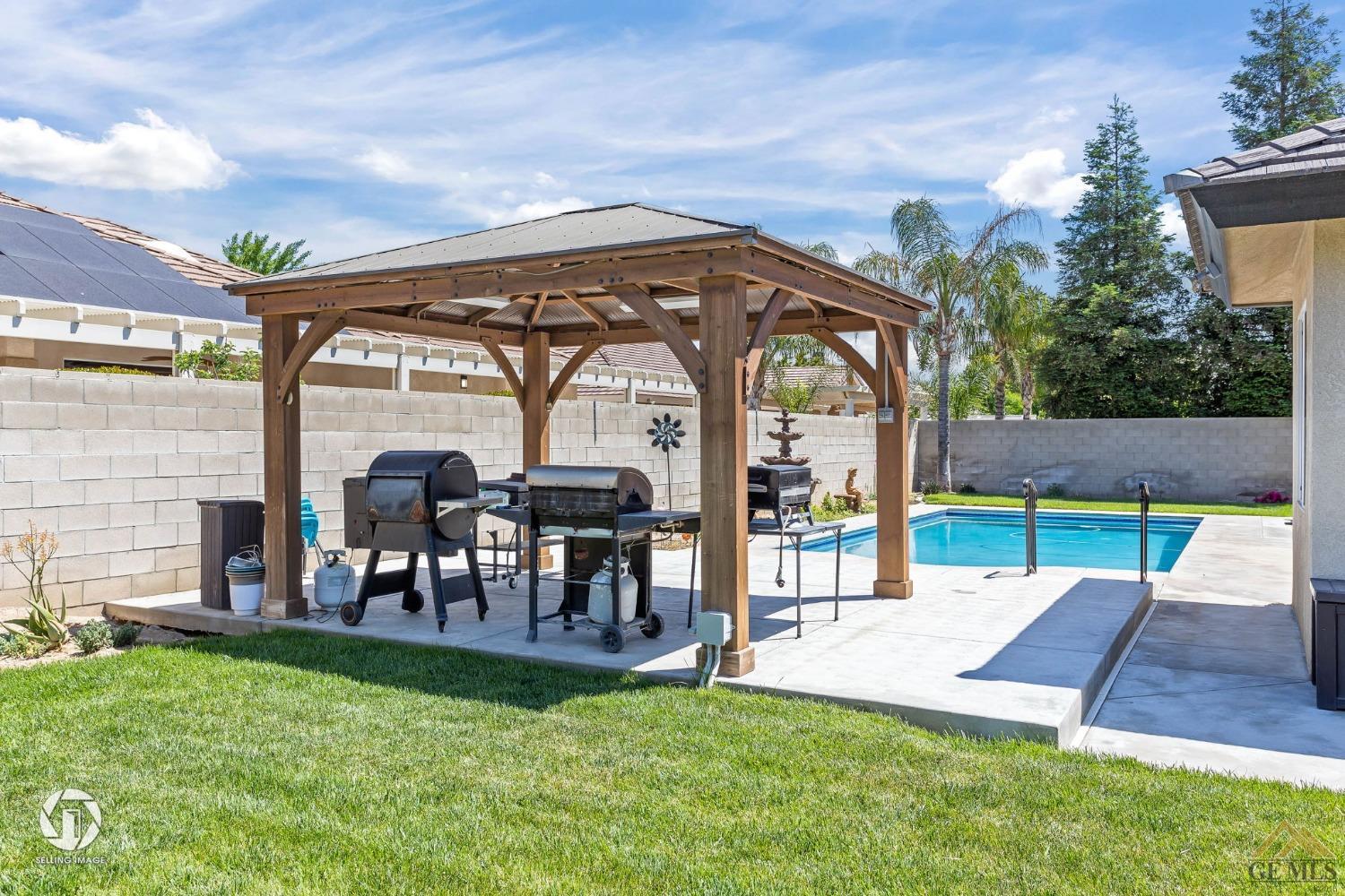 Undisclosed Address Bakersfield, CA 93313 - Photo 49 of 50 a view of a chairs and table in backyard of the house