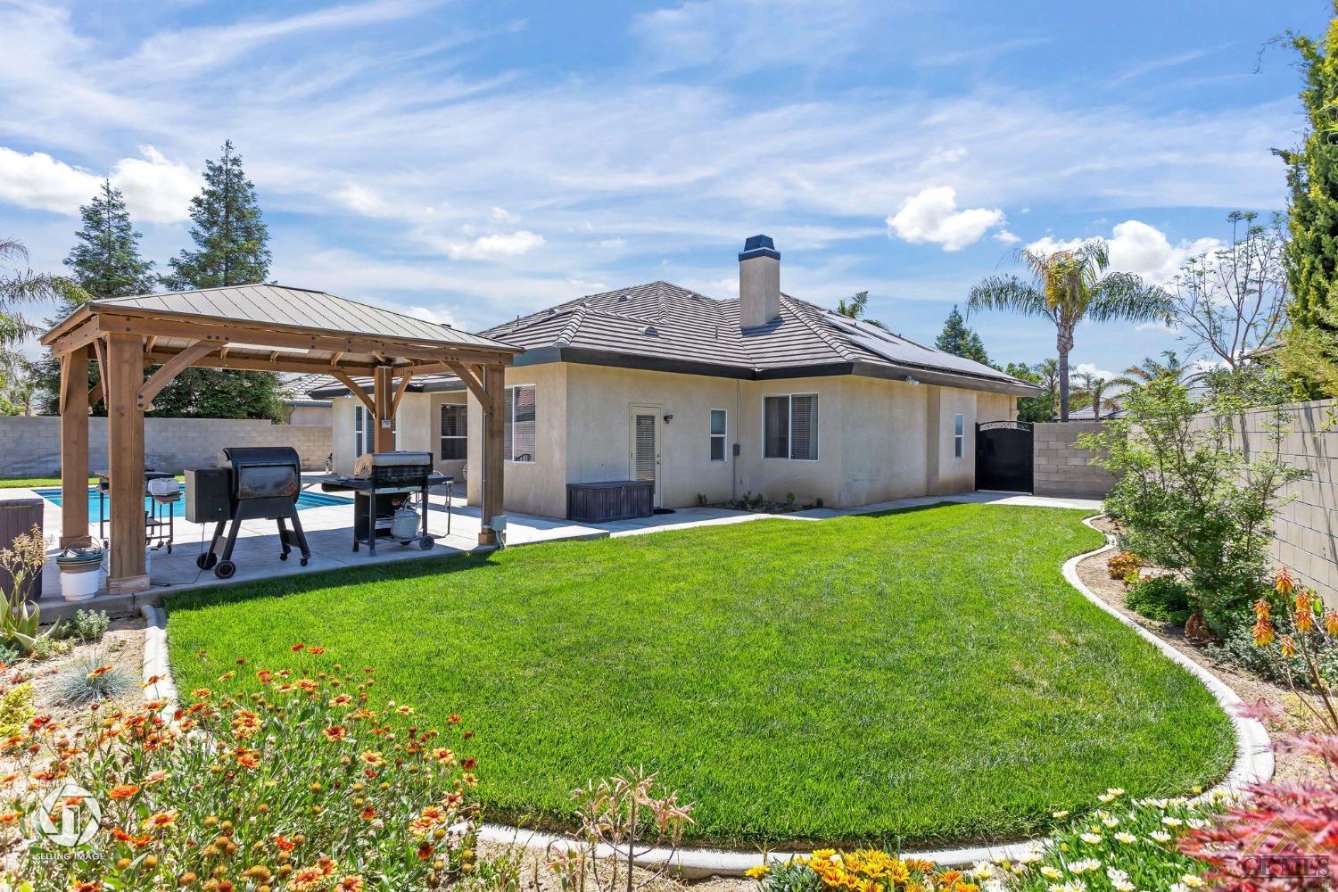 Undisclosed Address Bakersfield, CA 93313 - Photo 50 of 50 a front view of a house with garden