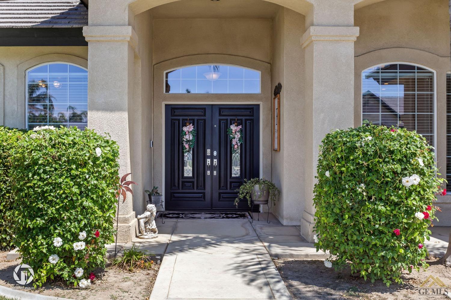 Undisclosed Address Bakersfield, CA 93313 - Photo 5 of 50 a front view of a house with garden