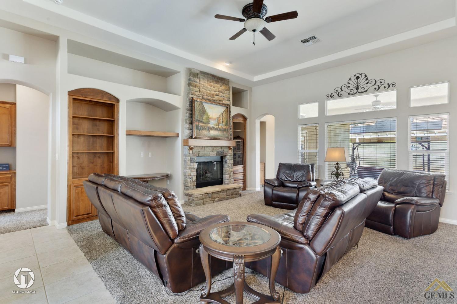 Undisclosed Address Bakersfield, CA 93313 - Photo 9 of 50 a living room with furniture a fireplace and a flat screen tv