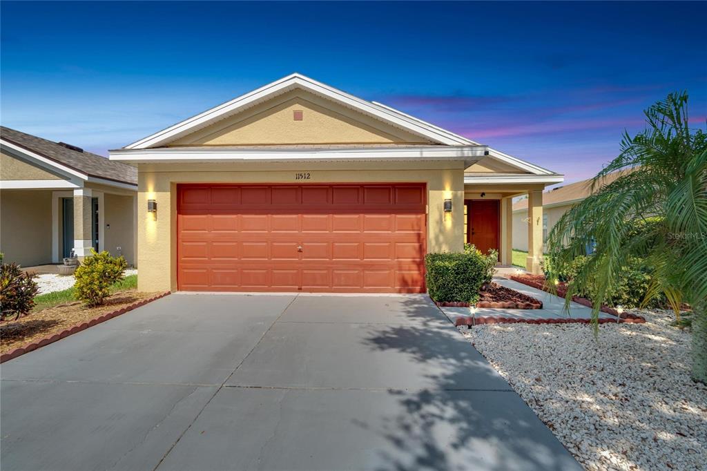 a front view of a house with a yard and garage