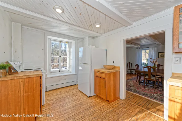 a view of a yard covered with snow in front of house