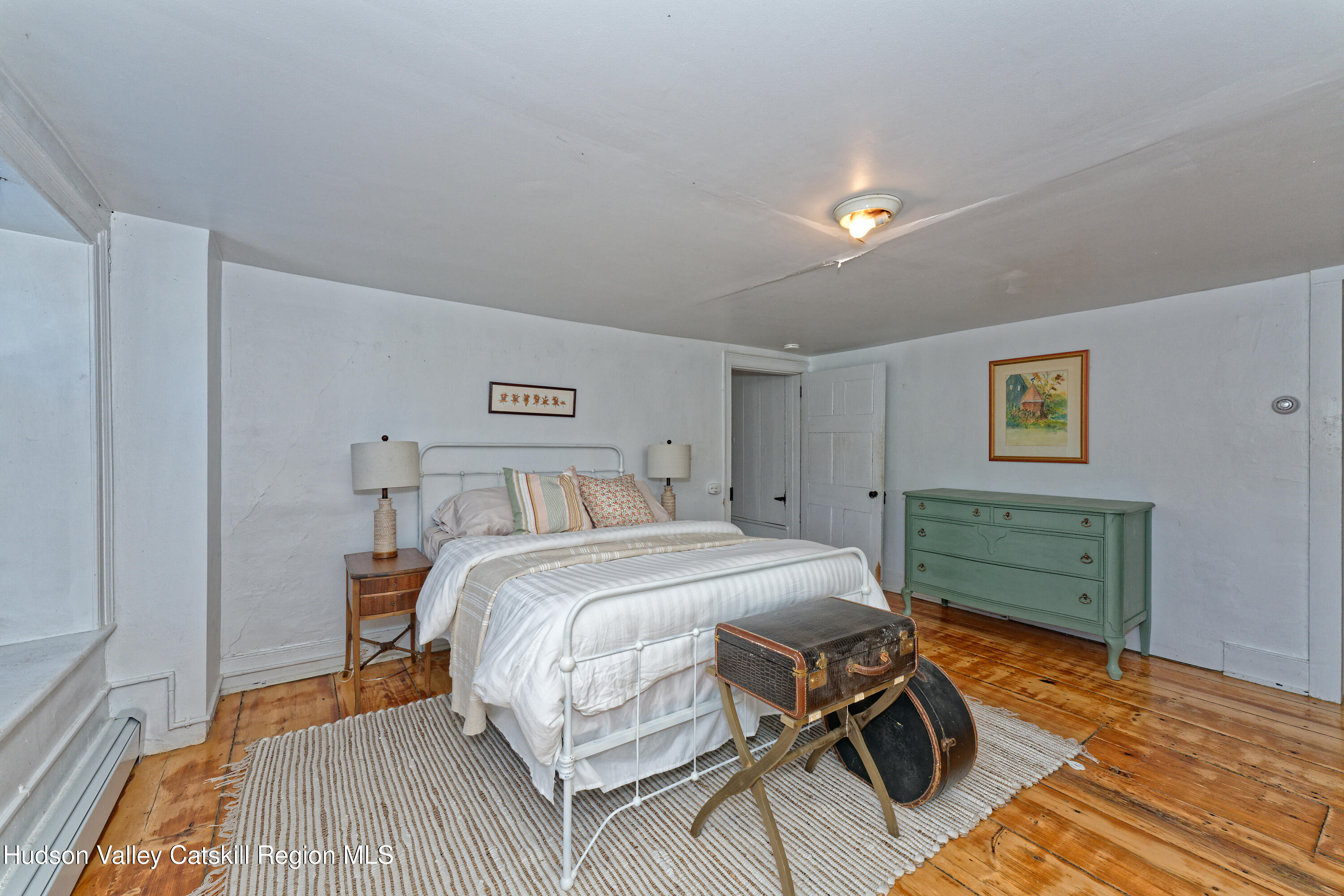 3953-3955 Highway 209 Stone Ridge, NY 12484 - Photo 22 of 69 a bedroom with a bed and a table in it
