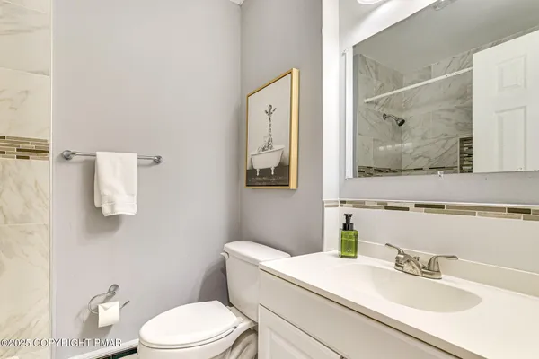 a bathroom with a sink toilet and mirror