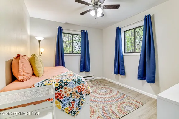 a bedroom with a bed and wooden floor