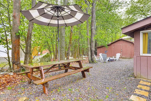 a backyard of a house with table and chairs