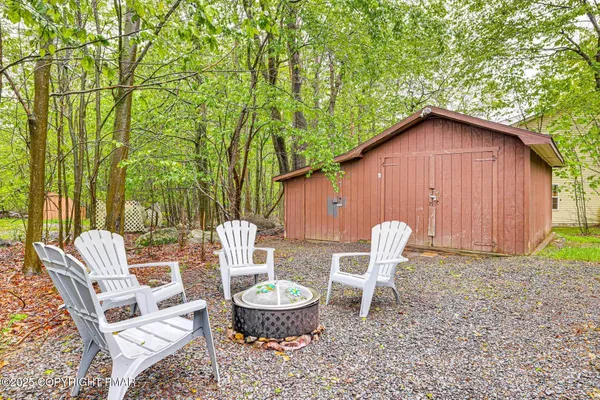 a view of a chair and table in backyard