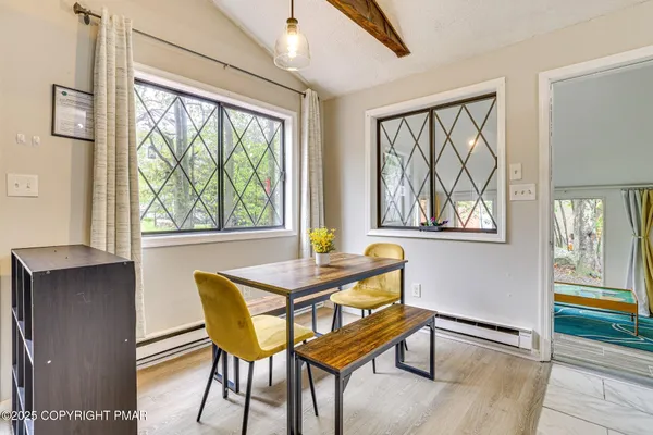 a dining room with furniture and windows