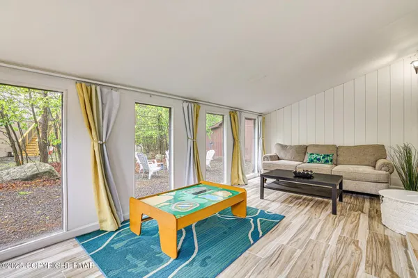 a living room with furniture and a wooden floor