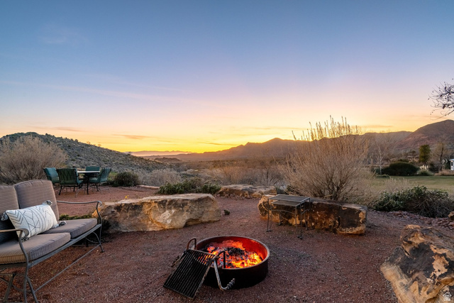 779 South Silver Road Leeds, UT 84746 - Photo 73 of 80 View of yard with a mountain view, an outdoor fire pit, a patio area, and outdoor dining area