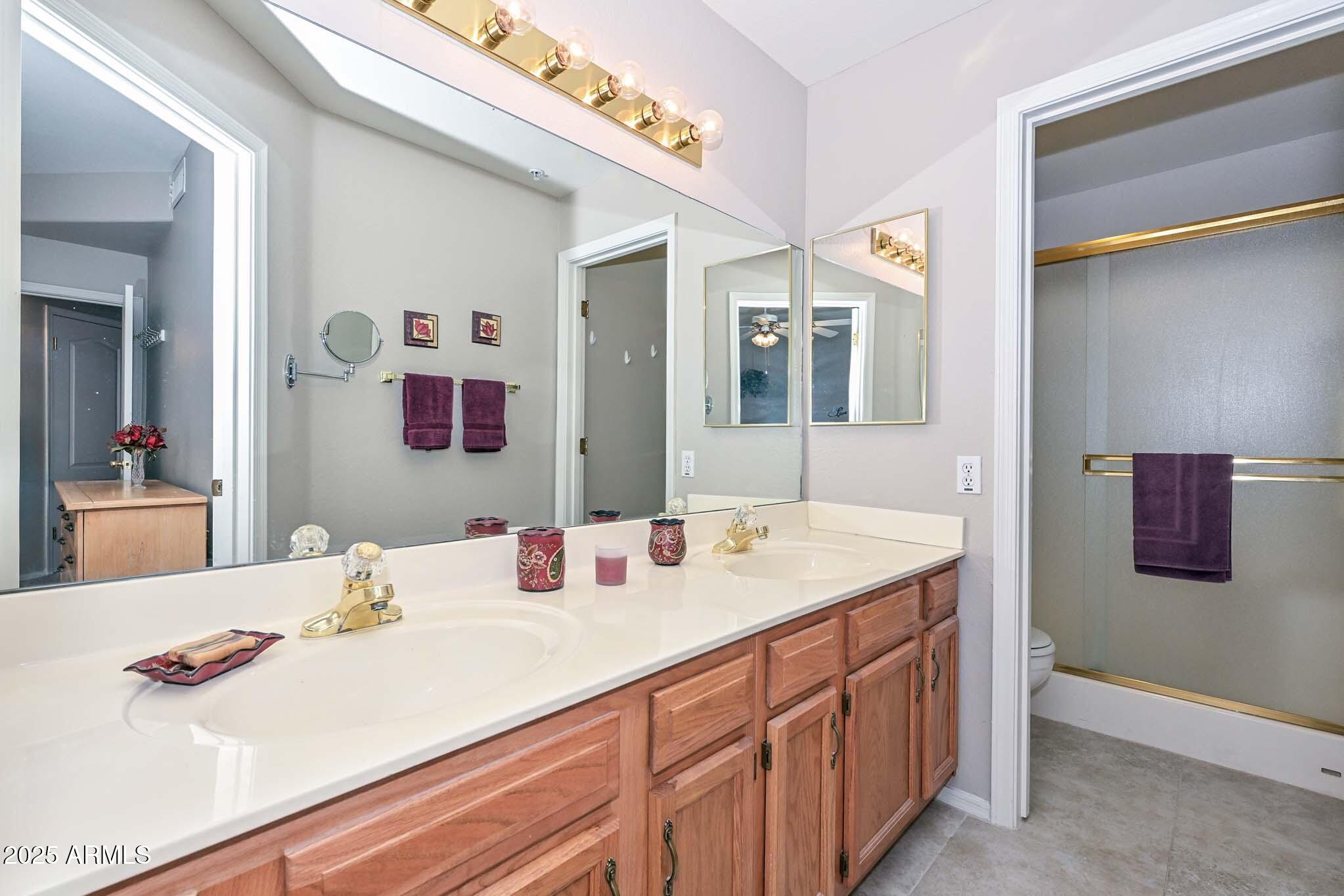 9151 West Greenway Road, Unit 113 Peoria, AZ 85381 - Photo 18 of 36 a bathroom with a sink and a mirror