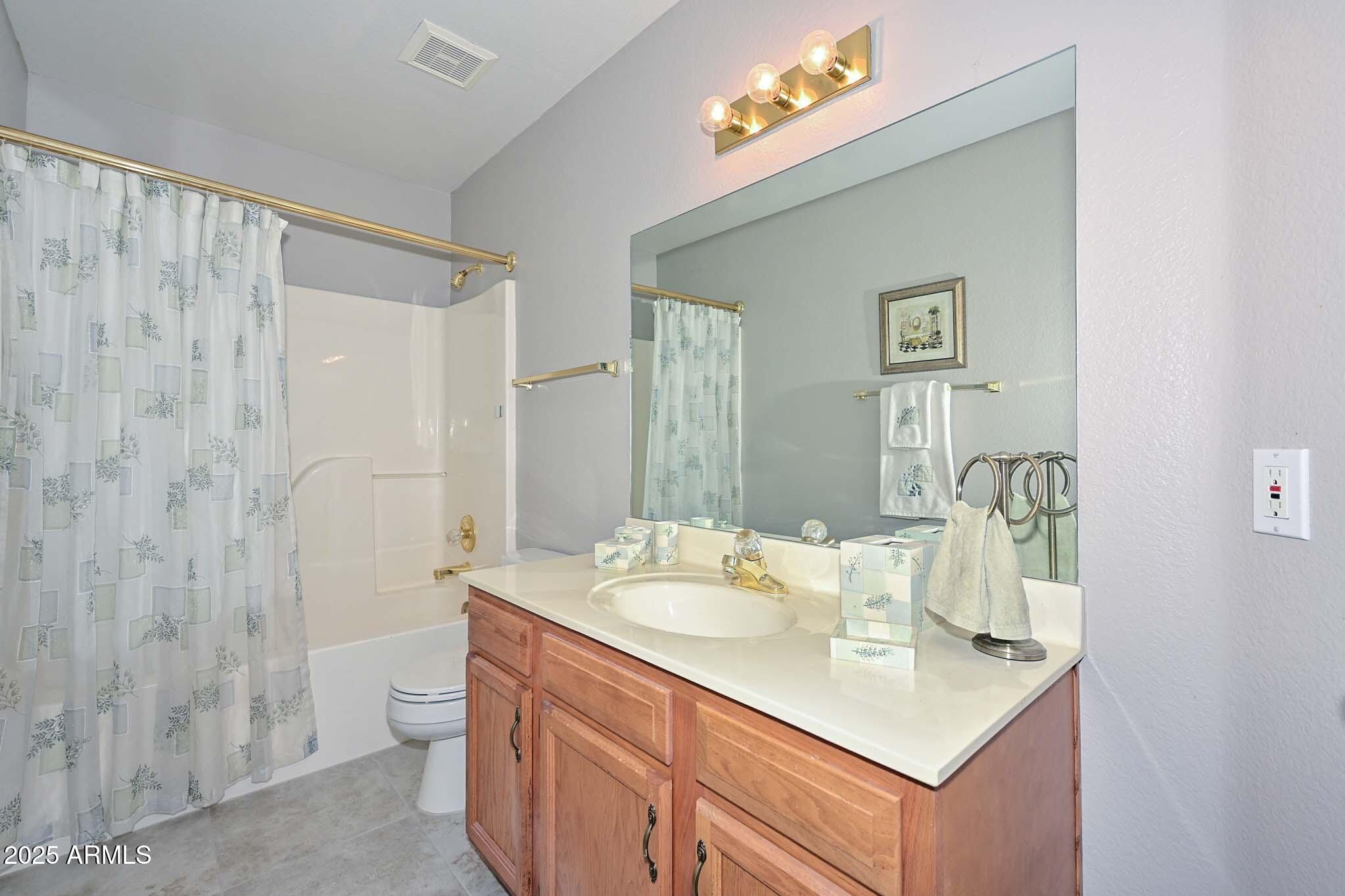 9151 West Greenway Road, Unit 113 Peoria, AZ 85381 - Photo 21 of 36 a bathroom with a sink vanity mirror and toilet