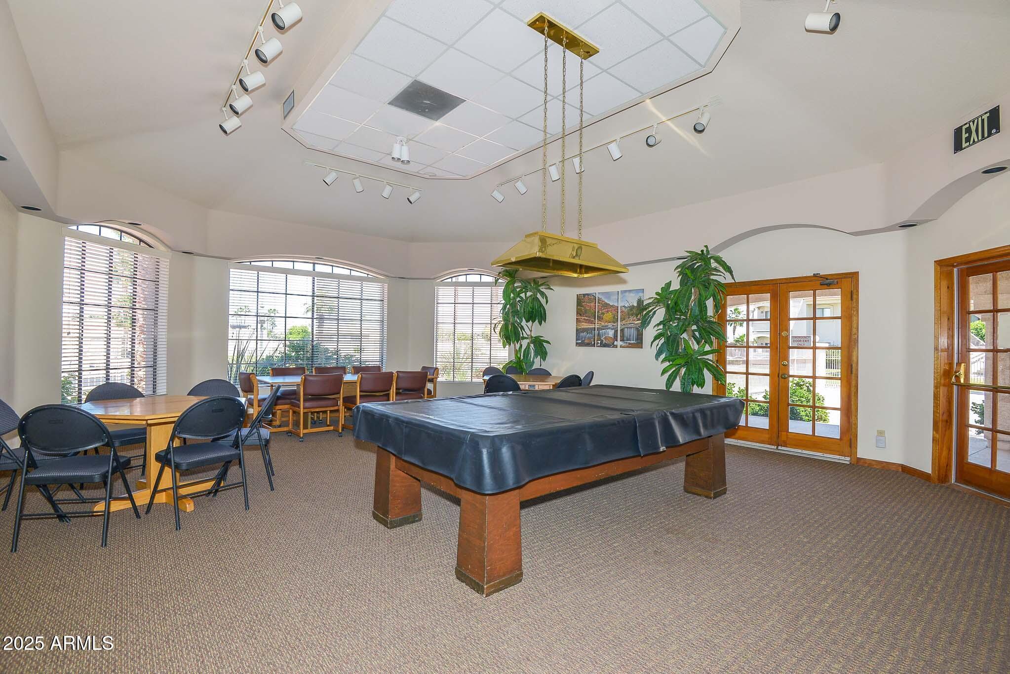9151 West Greenway Road, Unit 113 Peoria, AZ 85381 - Photo 34 of 36 a living room with furniture a large window and chandelier