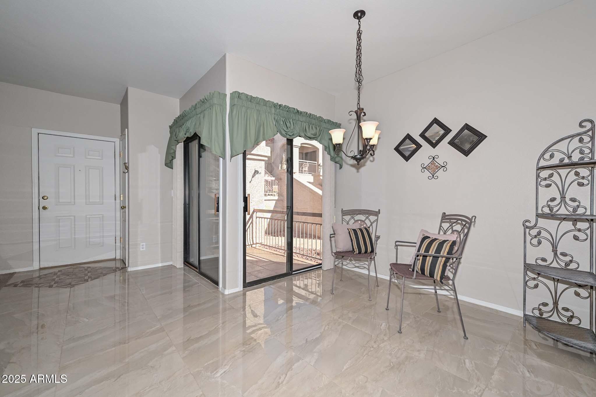 9151 West Greenway Road, Unit 113 Peoria, AZ 85381 - Photo 7 of 36 a dining room with furniture and window