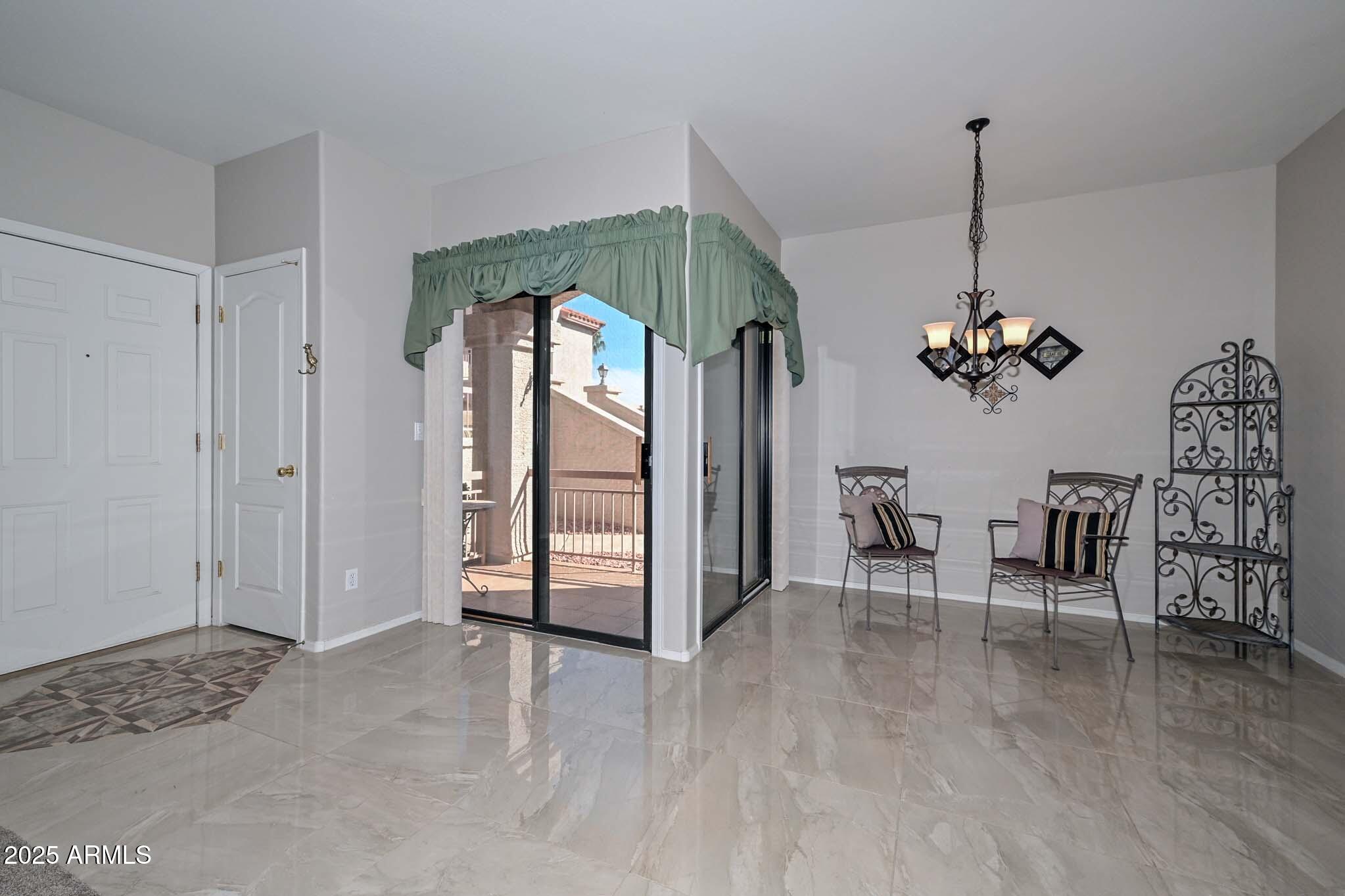 9151 West Greenway Road, Unit 113 Peoria, AZ 85381 - Photo 8 of 36 a view of a livingroom with furniture and window