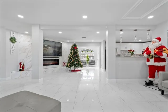 a living room with furniture flowers and a fireplace