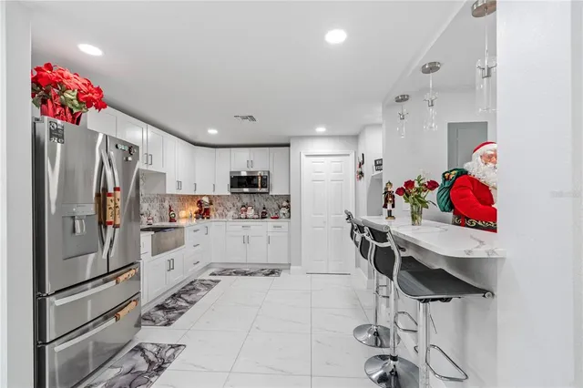 a view of a workspace with furniture and a potted plant